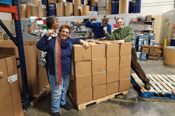 Members of the Miskin Team volunteering at MUST Ministries, after packing many boxes of food